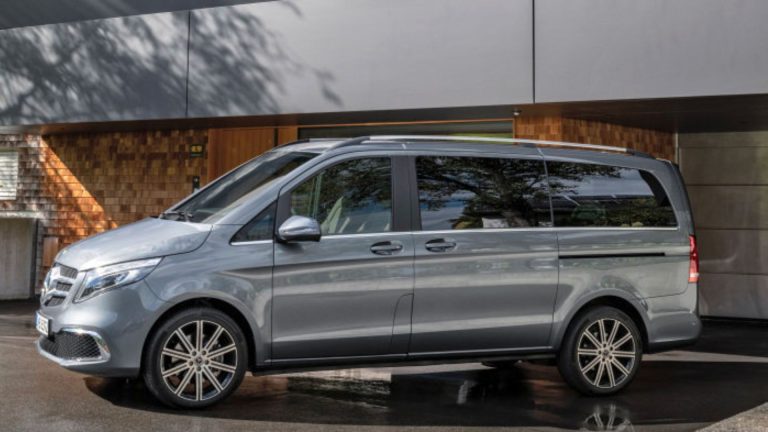 a silver van parked in front of a building.