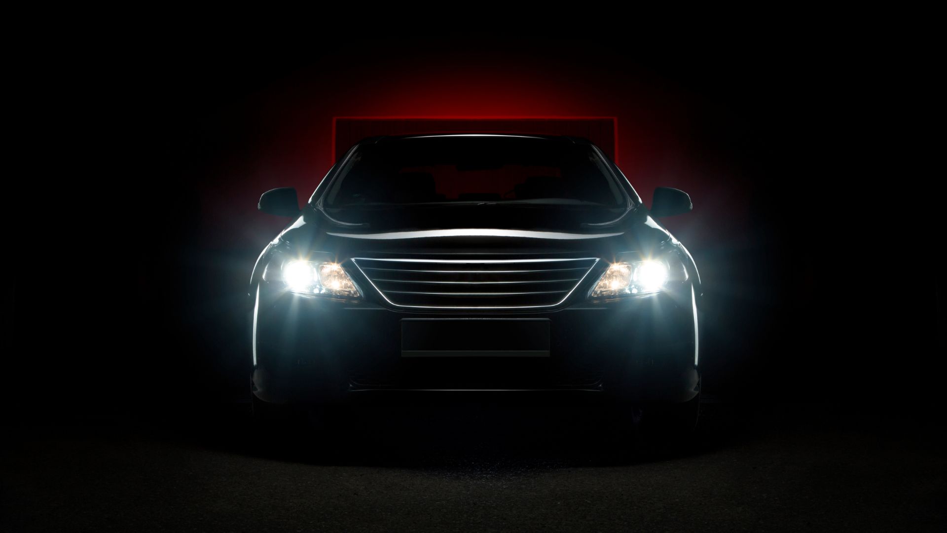 a car with its headlights on in the dark.