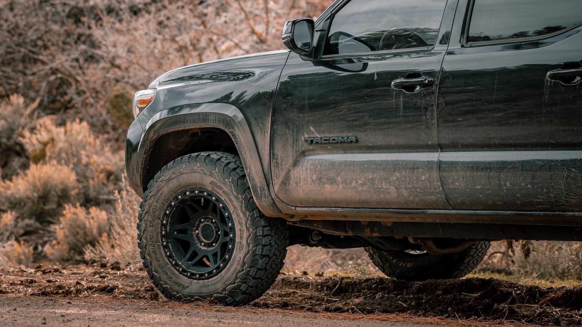 a close up of a truck on a dirt road.