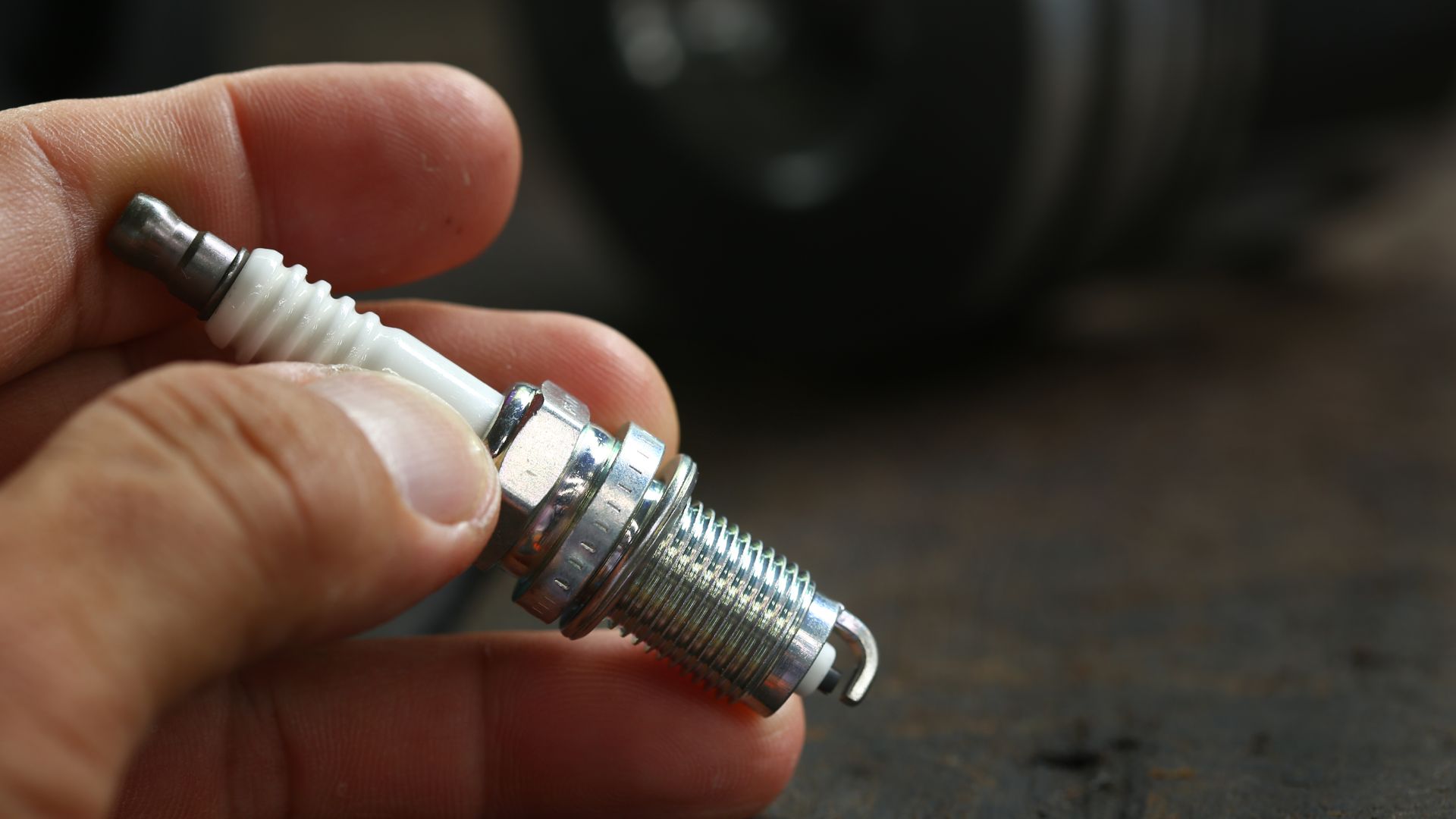 a person holding a small metal object in their hand.