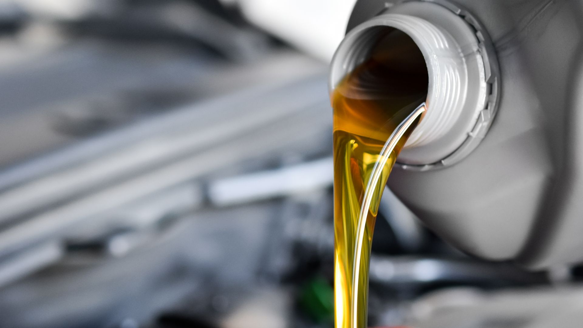 a close up of oil pouring out of a can.