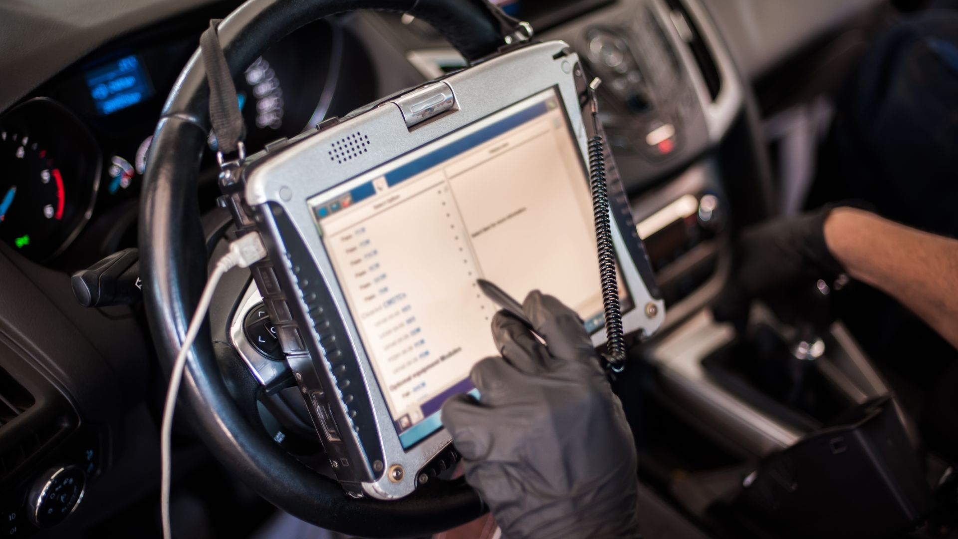 a person in a car holding a tablet.