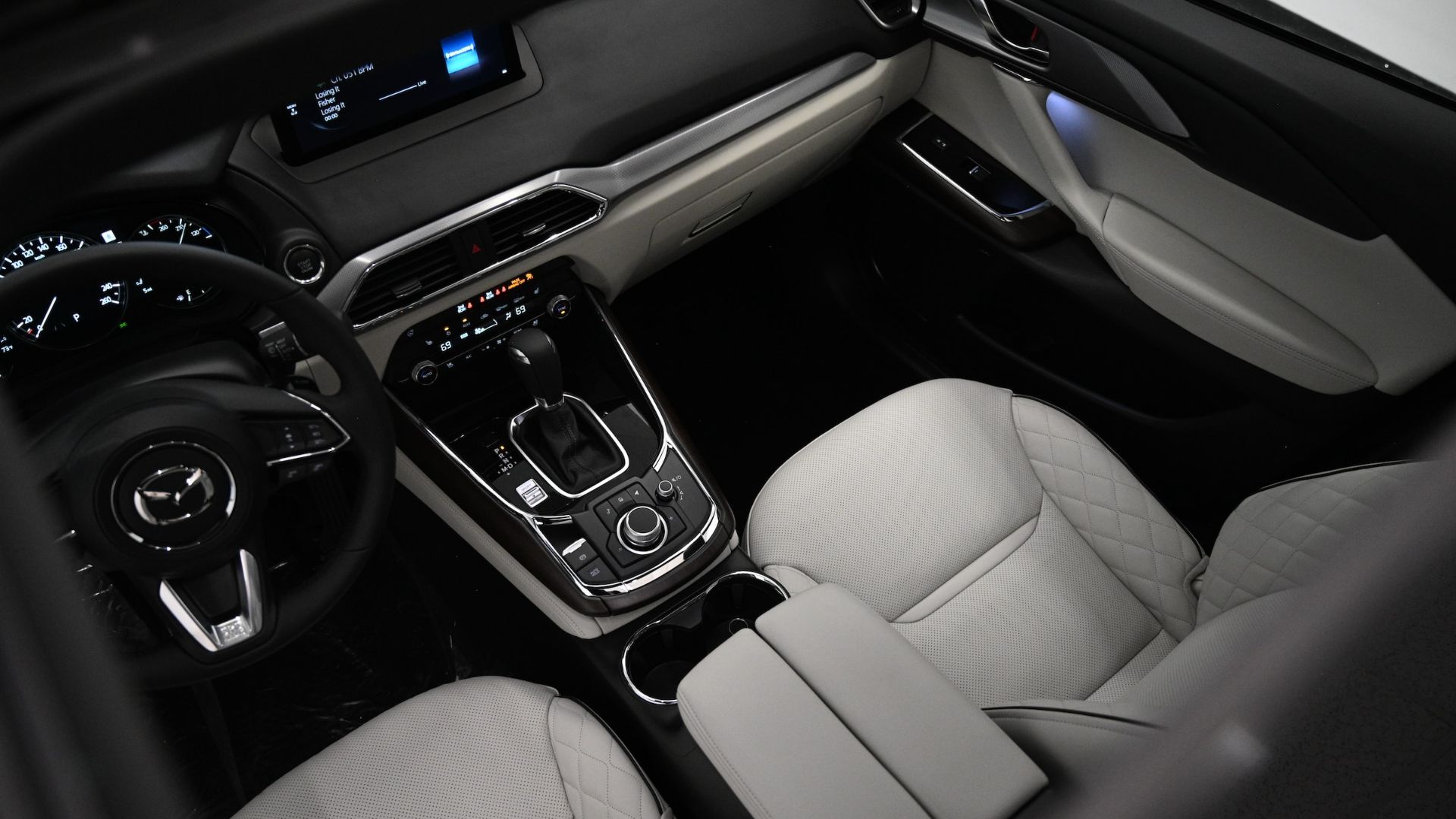 the interior of a car with white leather seats.