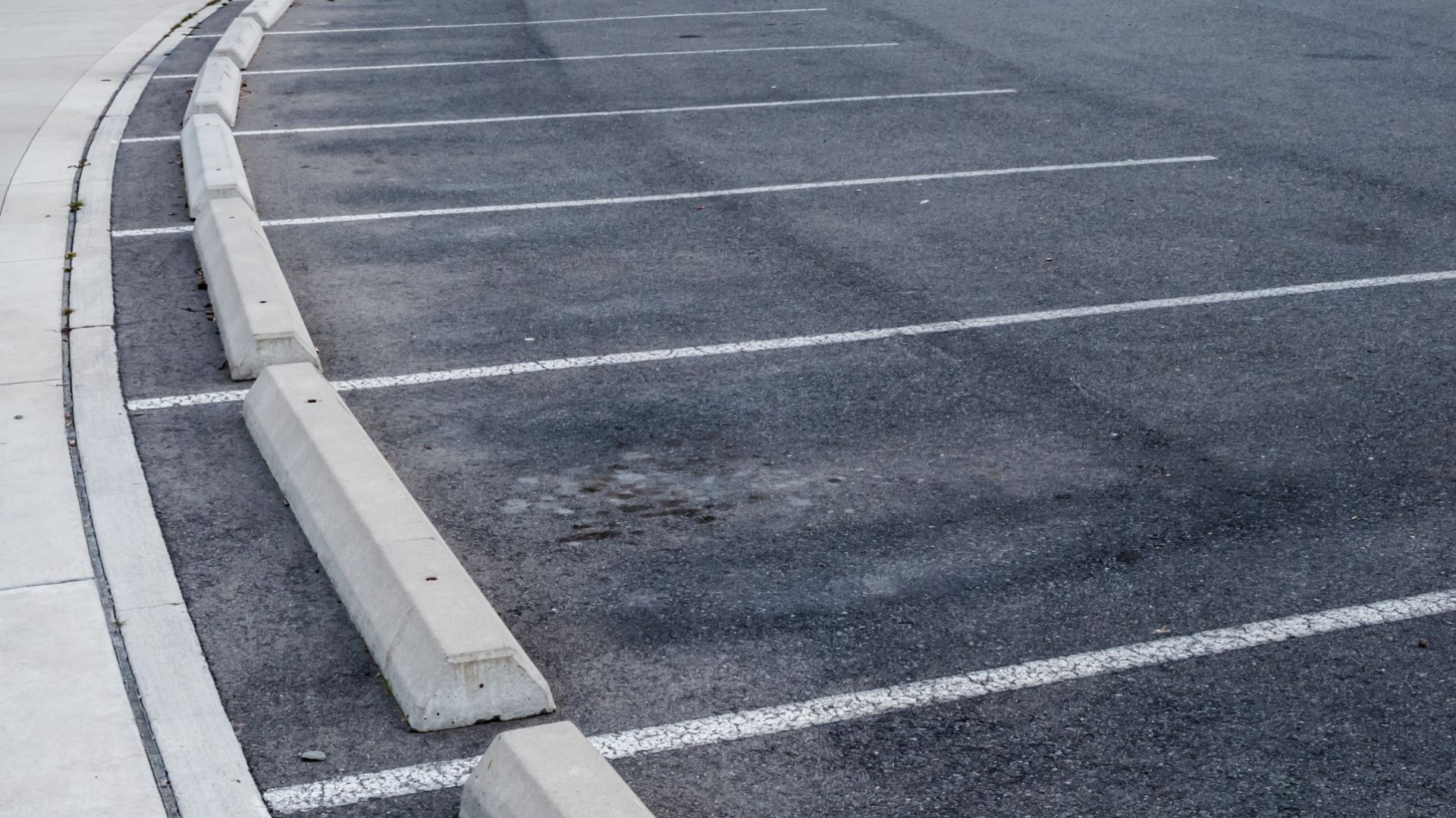 an empty parking lot with a fire hydrant.