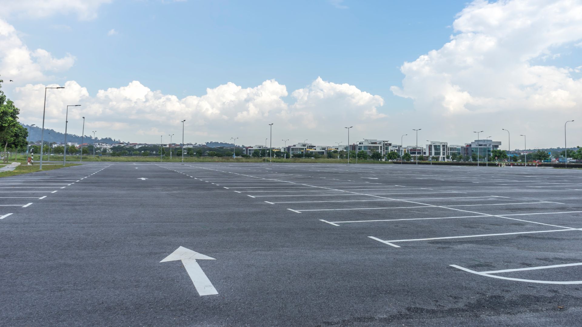 an empty parking lot with an arrow painted on it.
