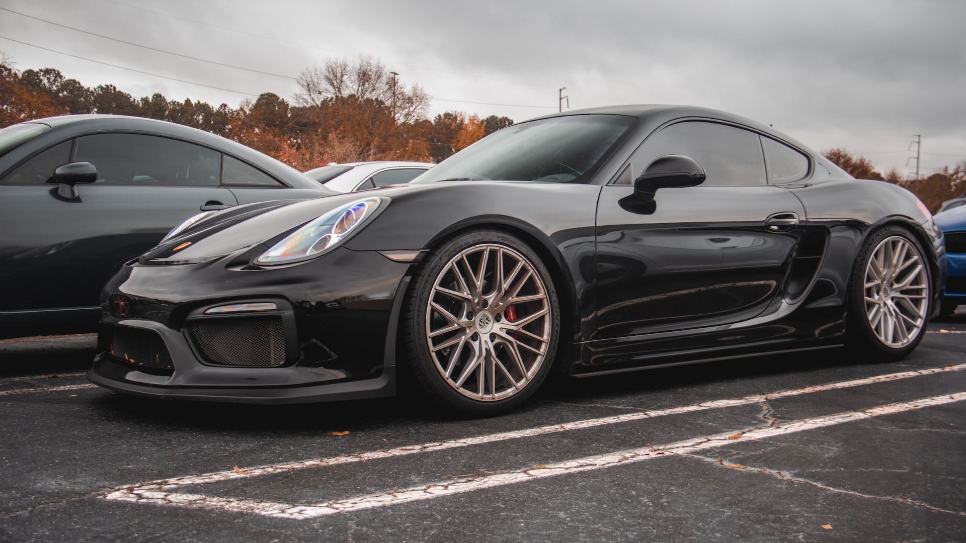 a black sports car parked in a parking lot.