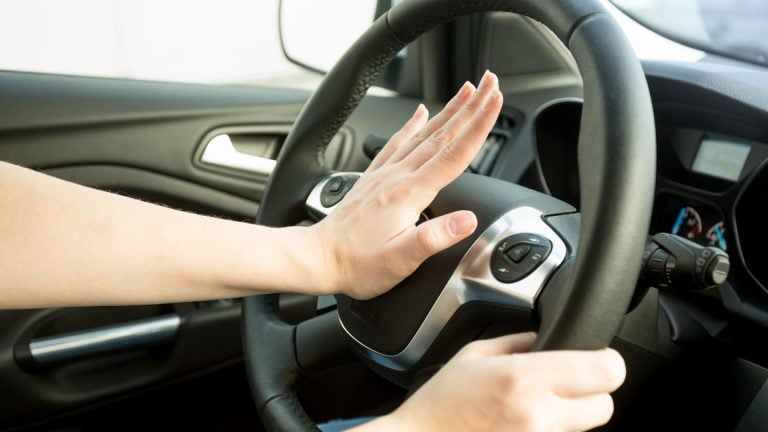 a person driving a car with their hands on the steering wheel.