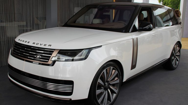 a white range rover parked inside of a building.