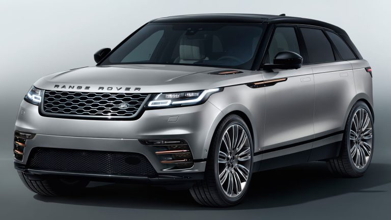 a silver range rover parked in a studio.