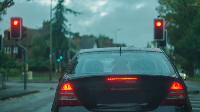 a car stopped at a red traffic light.