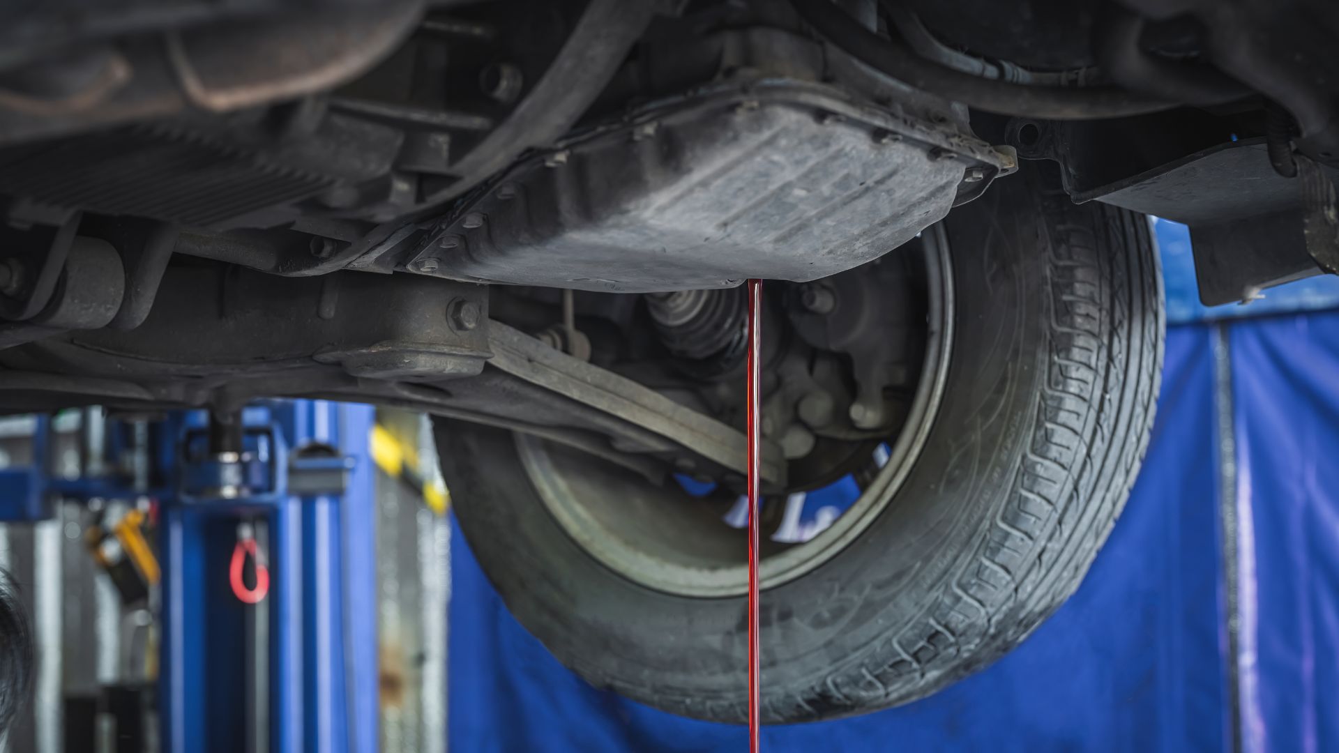 a close up of a car tire on a lift.