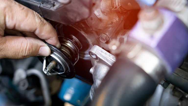 a close up of a person working on an engine.