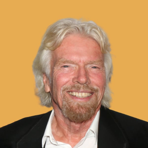 a man with white hair and a beard smiling.