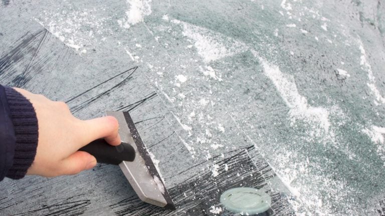 scraping the ice from the windshield