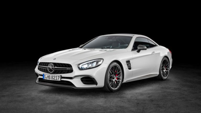 a white mercedes sports car on a black background.