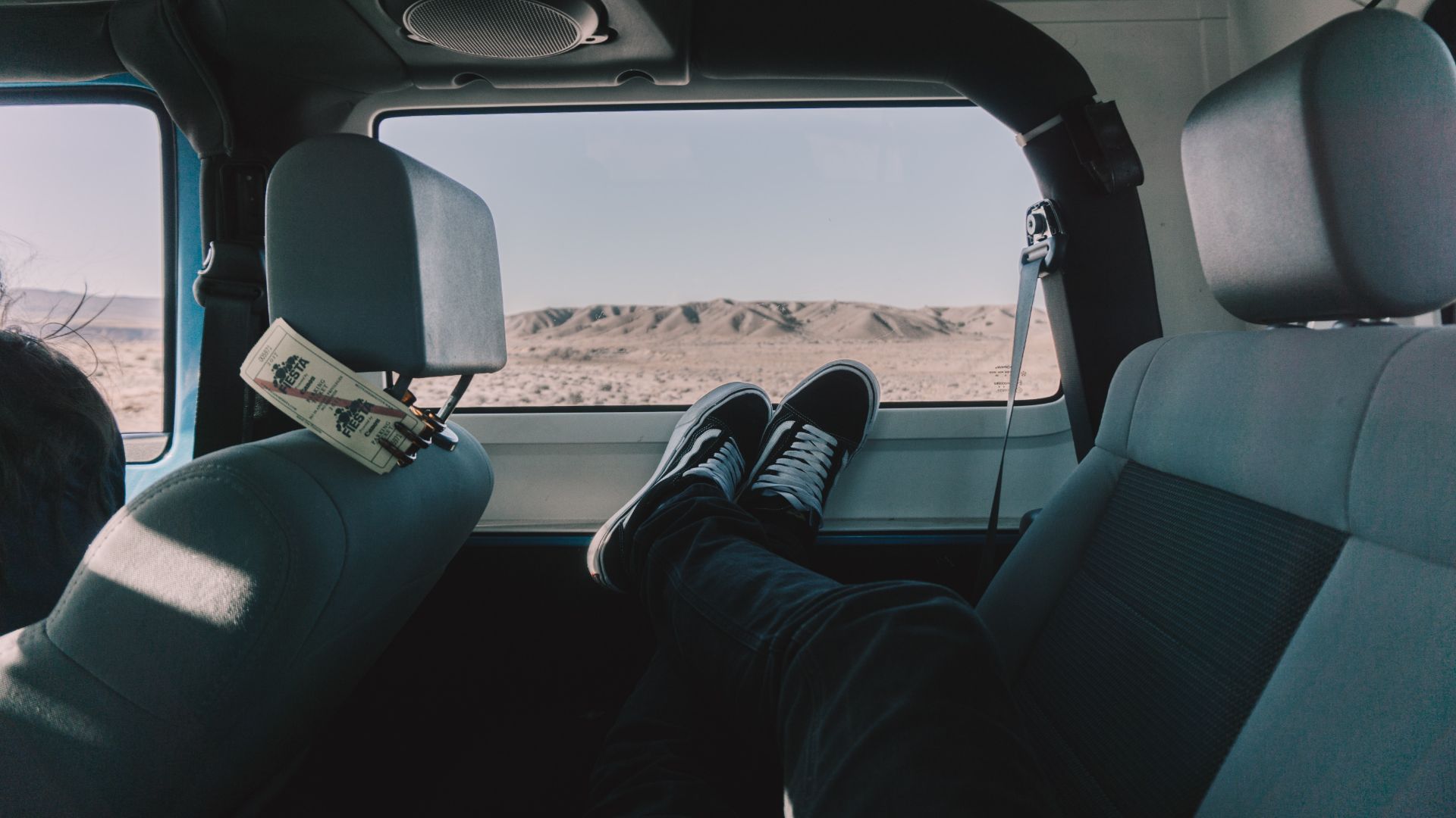 a person sitting in the back seat of a van.