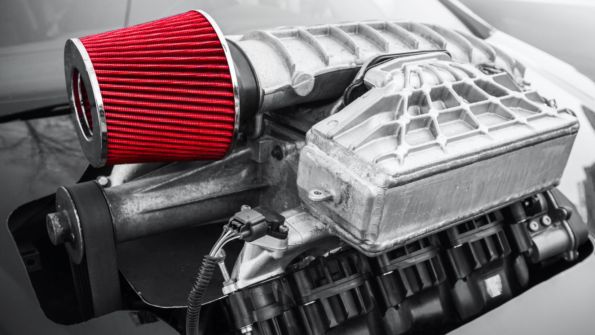 a close up of a car engine with a red filter.