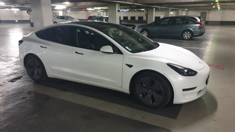 a white car parked in a parking garage.