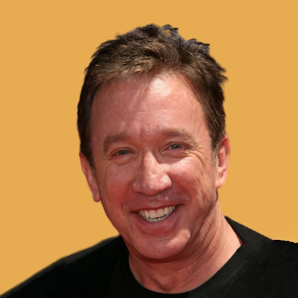 a smiling man in a black shirt and a yellow background.