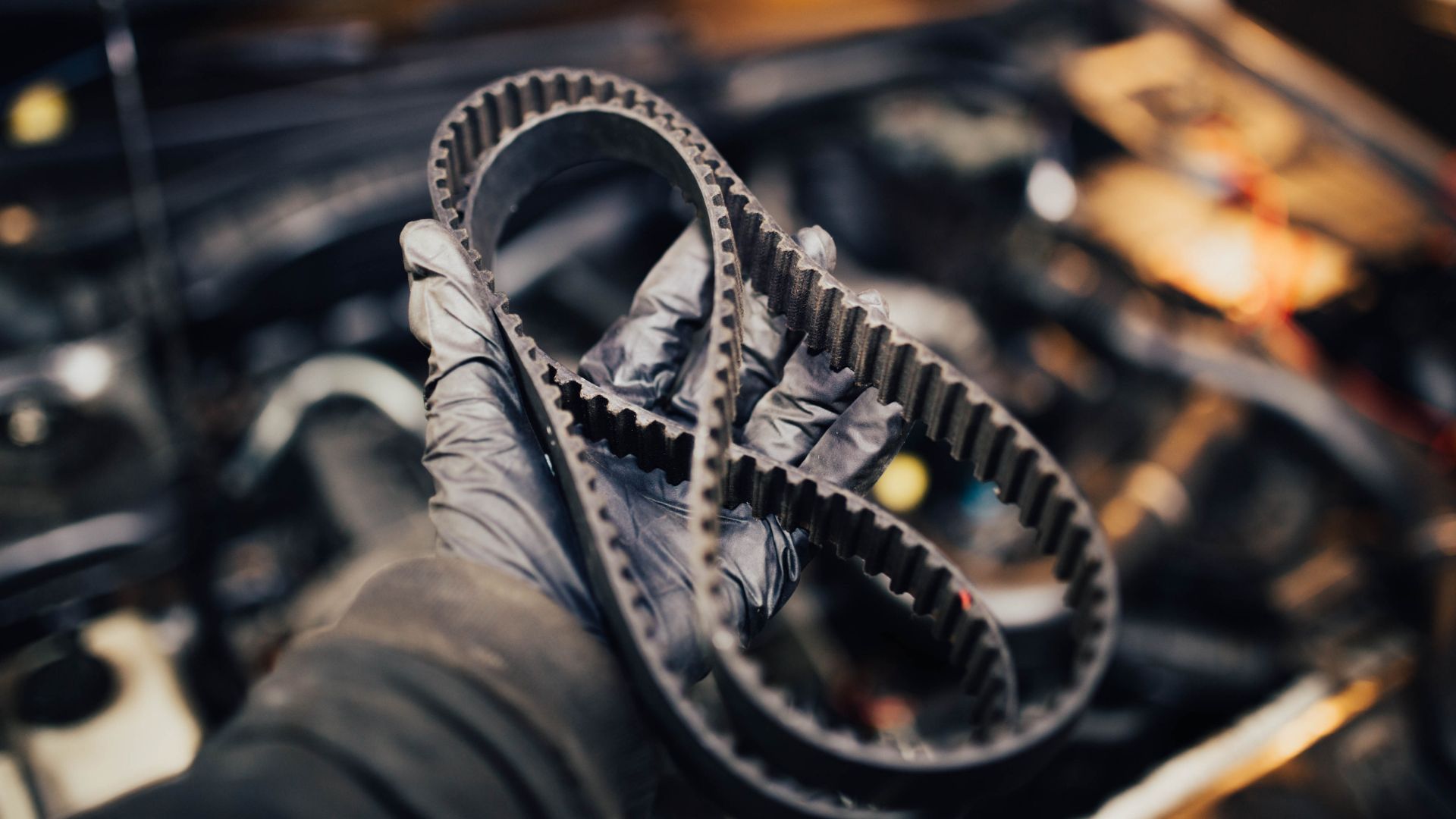 a close up of a person holding a pair of gears.