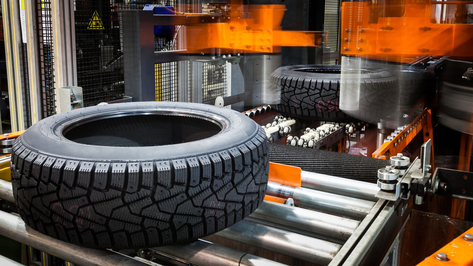 a tire on a conveyor belt in a factory.