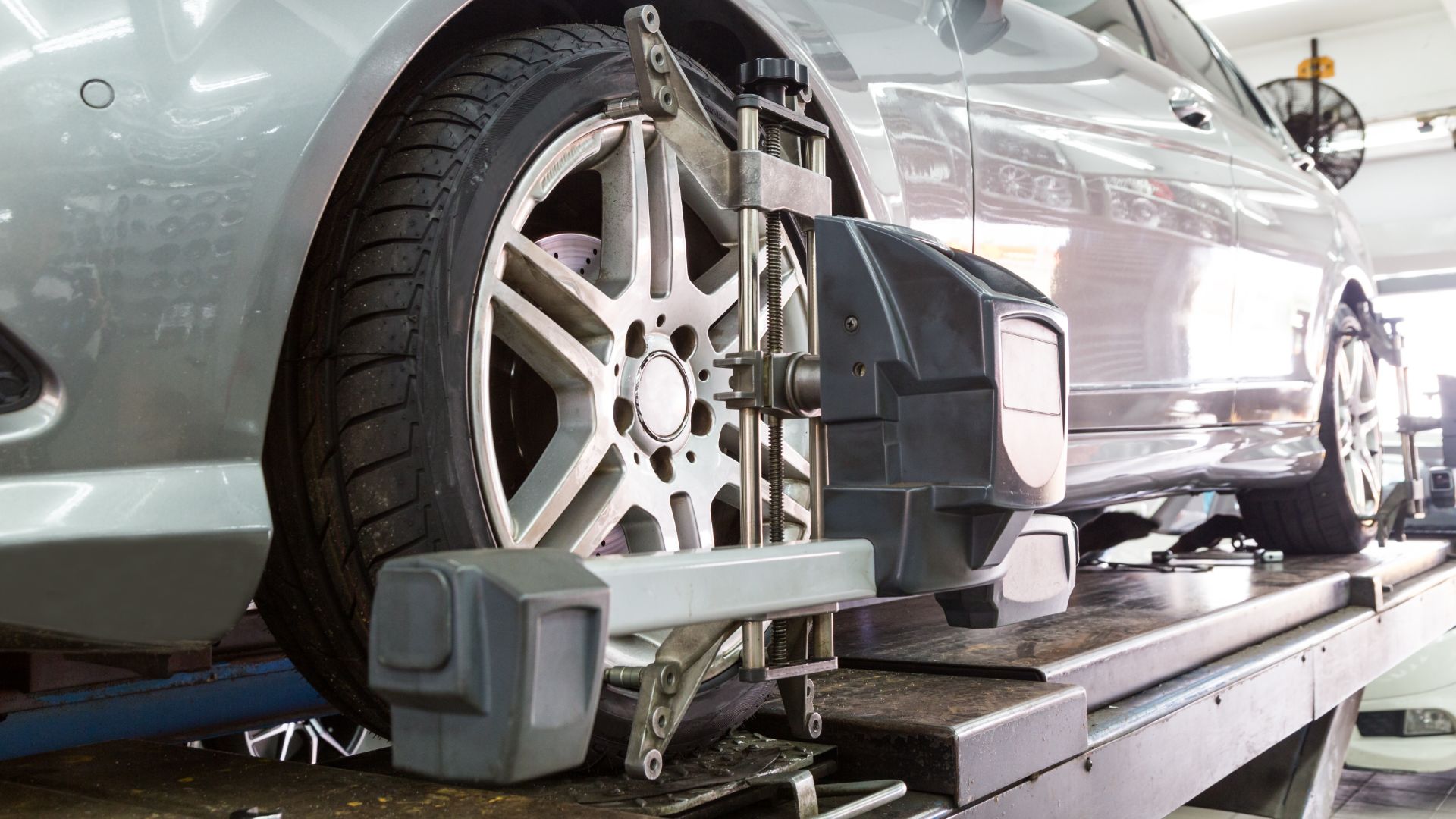 a car being worked on by a mechanic.