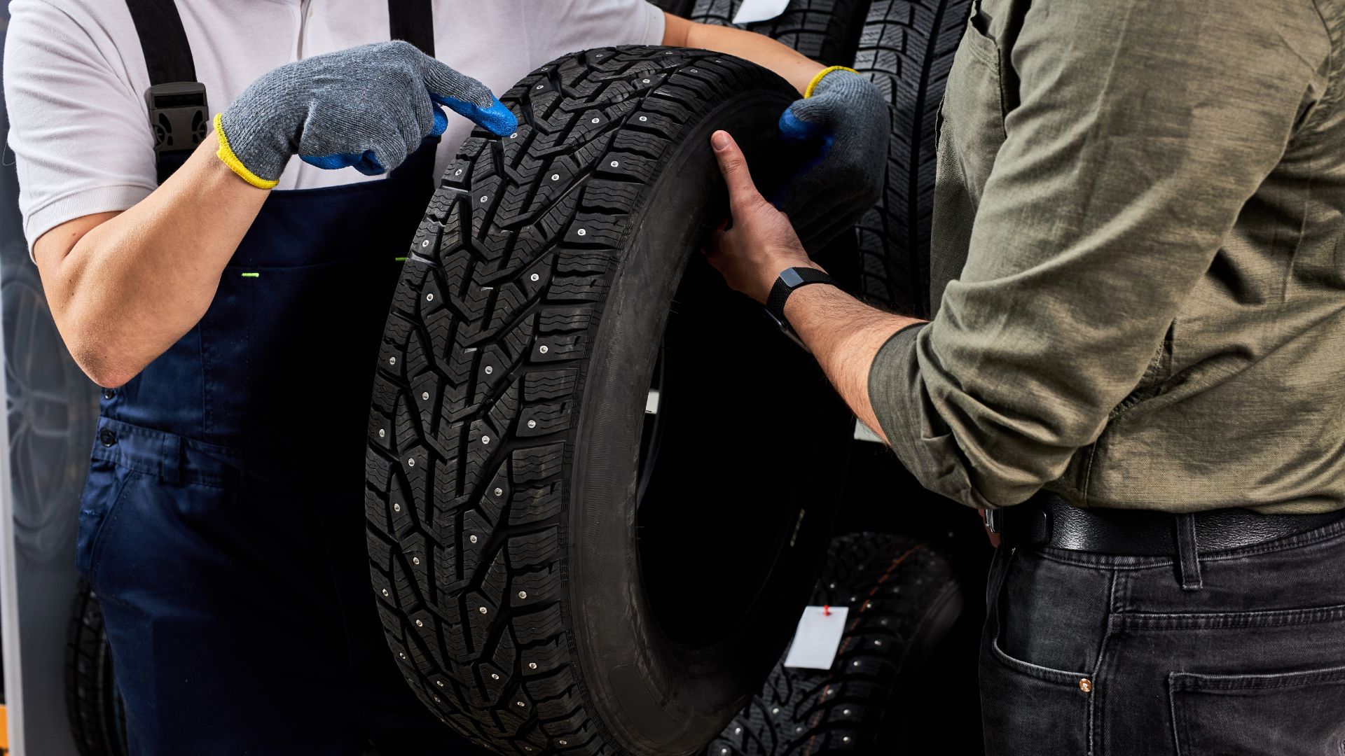 a group of men working on a tire.