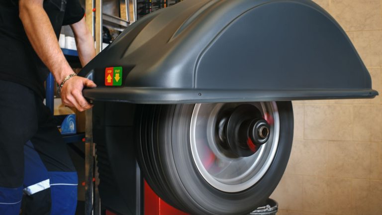 a man working on a machine in a shop.