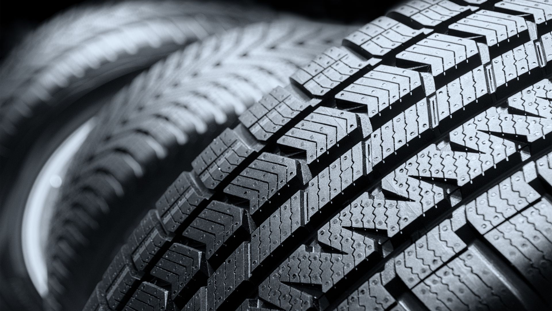 a close up of a tire on a black background.