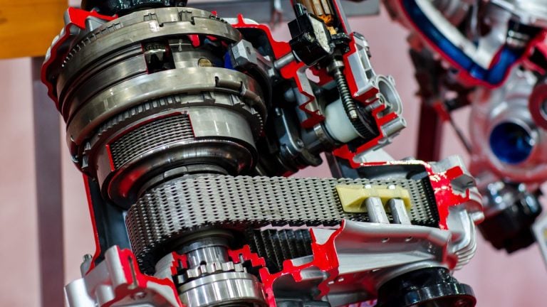 a close up of a metal object with a red background.