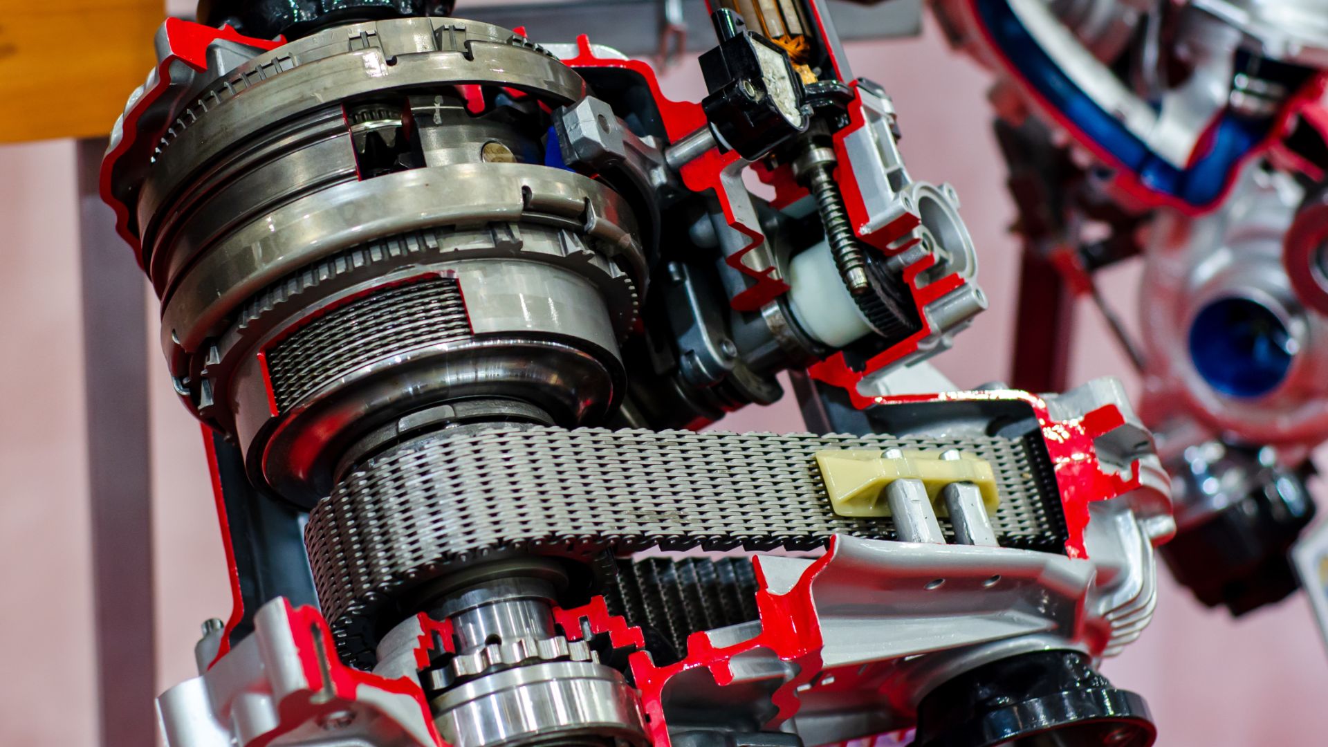 a close up of a metal object with a red background.