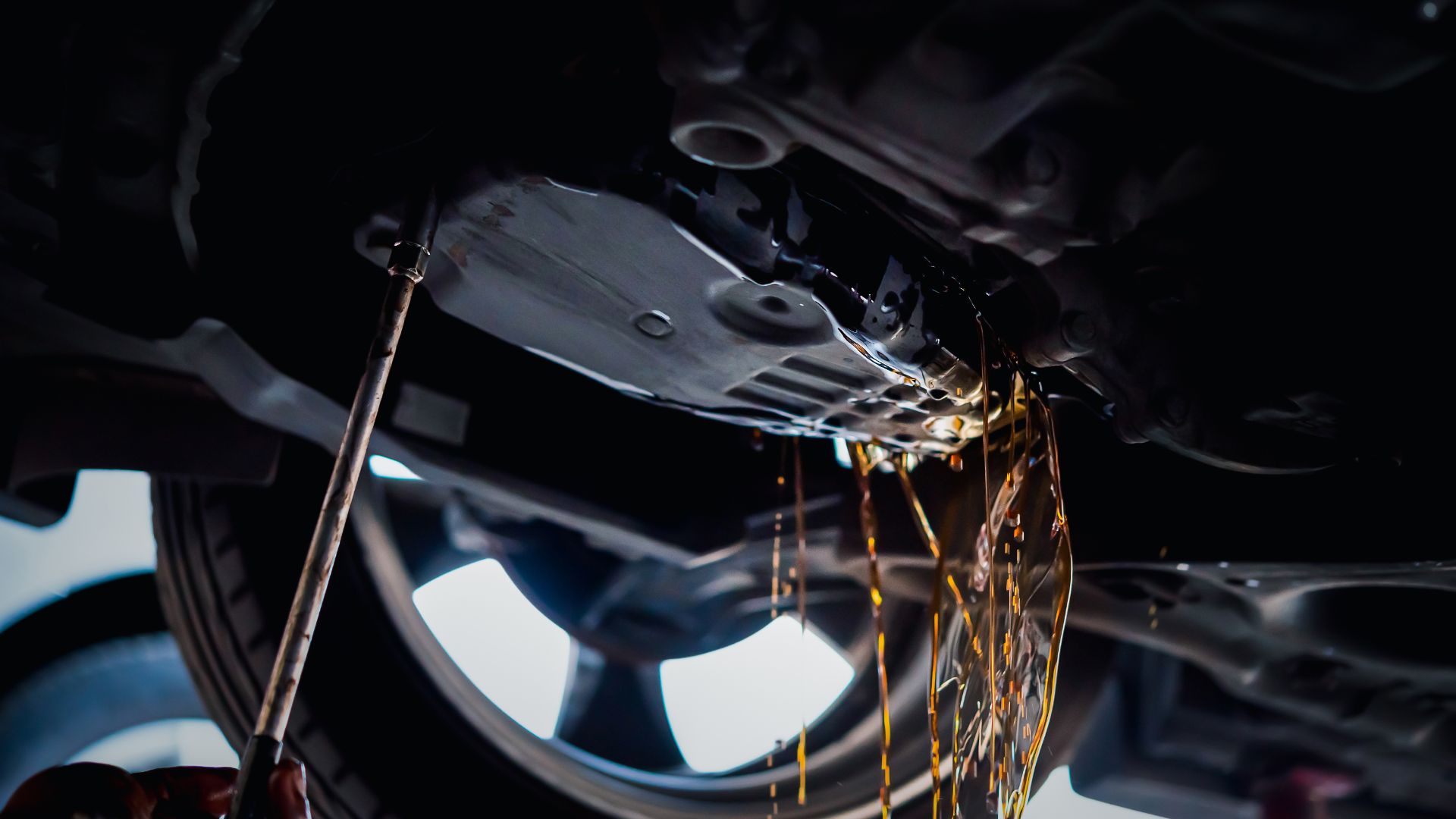 a man is working on a car's brake assembly.