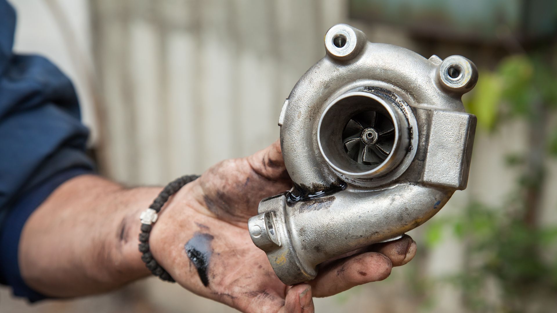 a close up of a person holding a metal object.