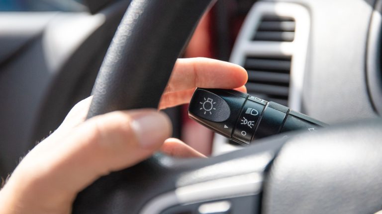 a person holding a remote control in a car.