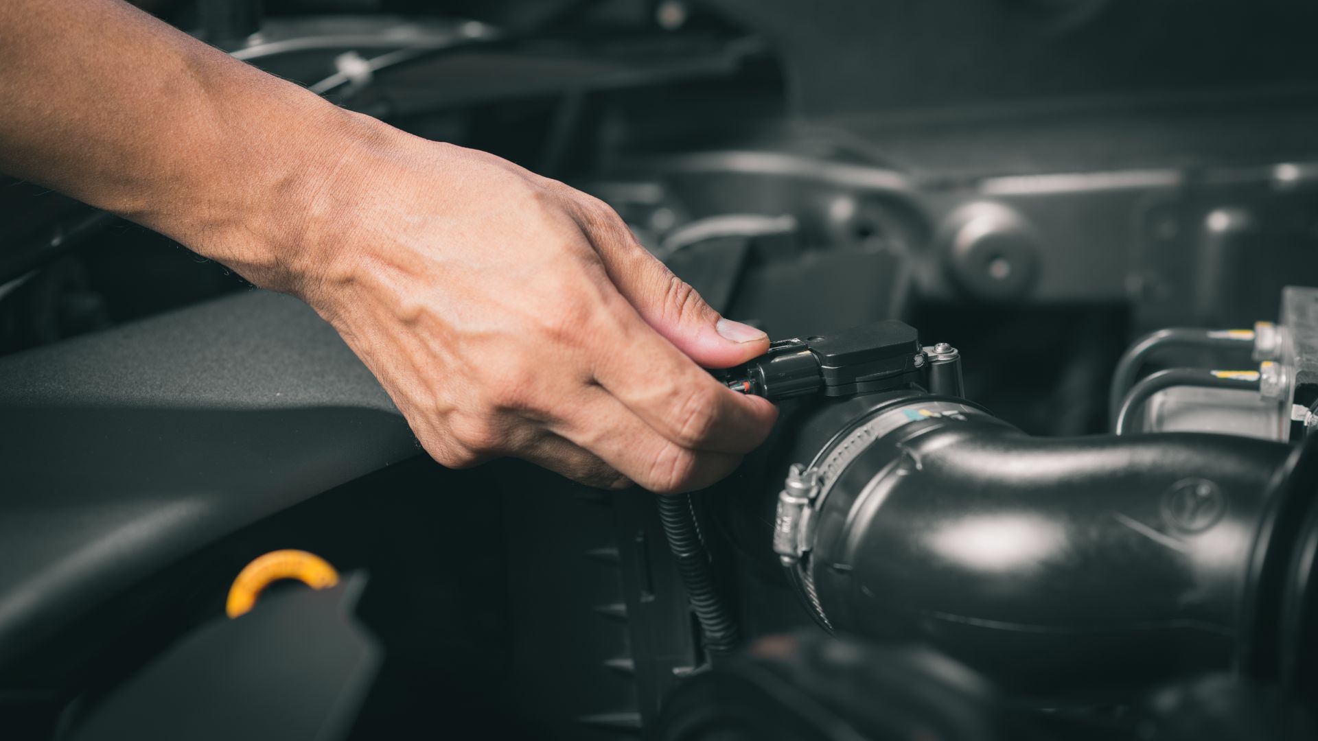 a man is working on a car engine.