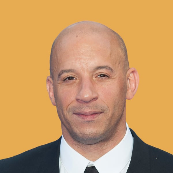a bald man wearing a suit and tie.
