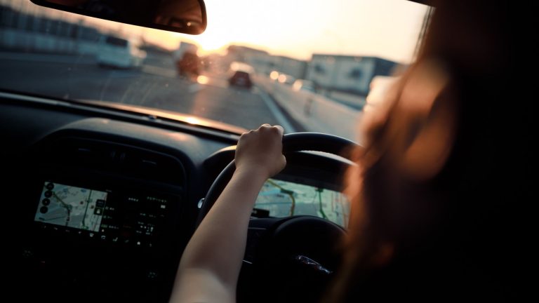 a person driving a car on a highway.